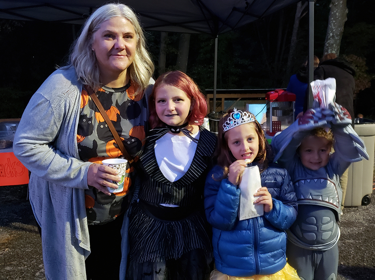 A family dressed for Halloween attends the fall harvest party at Bakerstown Alliance.